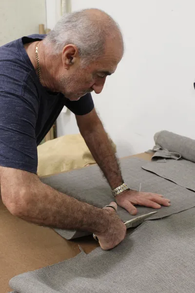 Arnold, ARED's founder and lead craftsman, working on upholstery in the workshop