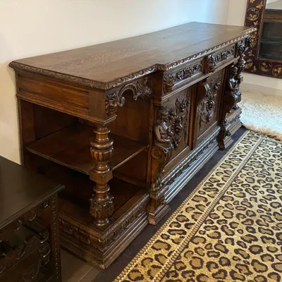 Restored ornate carved oak sideboard with turned columns and detailed relief work