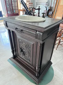 Carved antique washstand converted to bathroom vanity