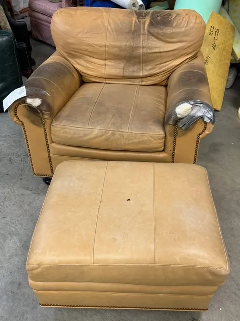 Before and after reupholstery of a leather club chair and ottoman with brass nailhead trim - before