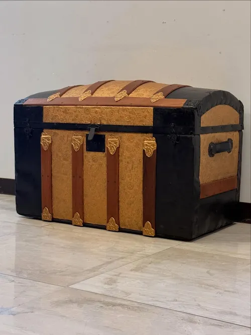 Restored antique steamer trunk with embossed tin panels and brass hardware